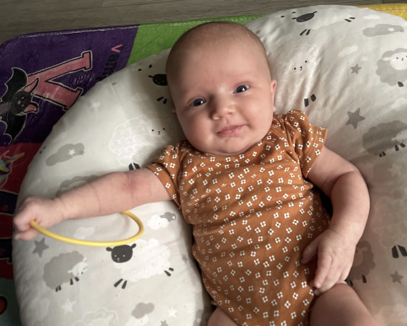 Baby smiling in the Mini Molecules program at The Lab Child Care Center in Easton, MD.